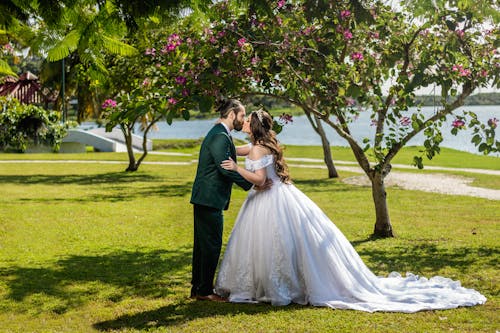 Newlyweds Kissing in Park