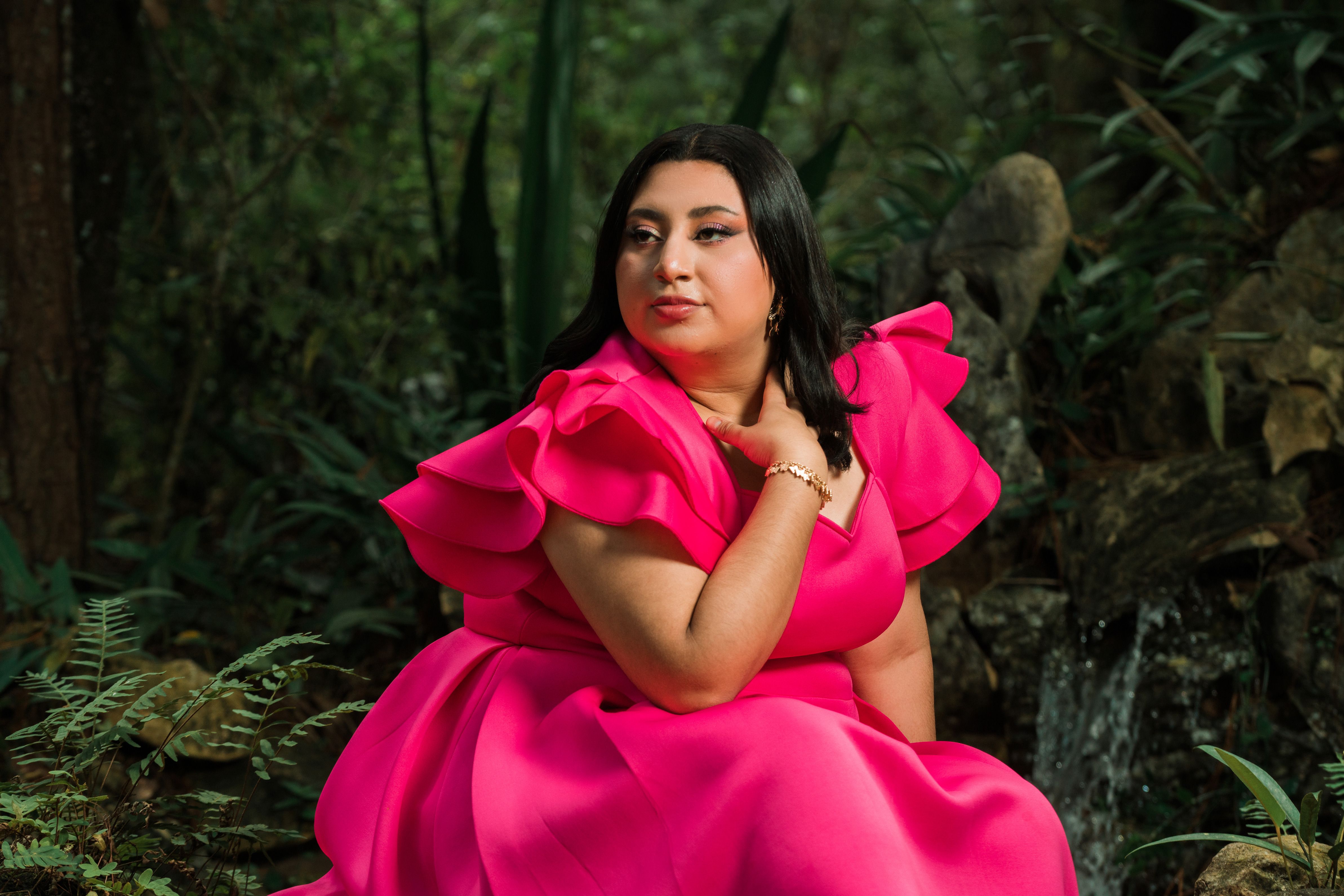 Woman Wearing a Pink Dress Posing in a Garden · Free Stock Photo