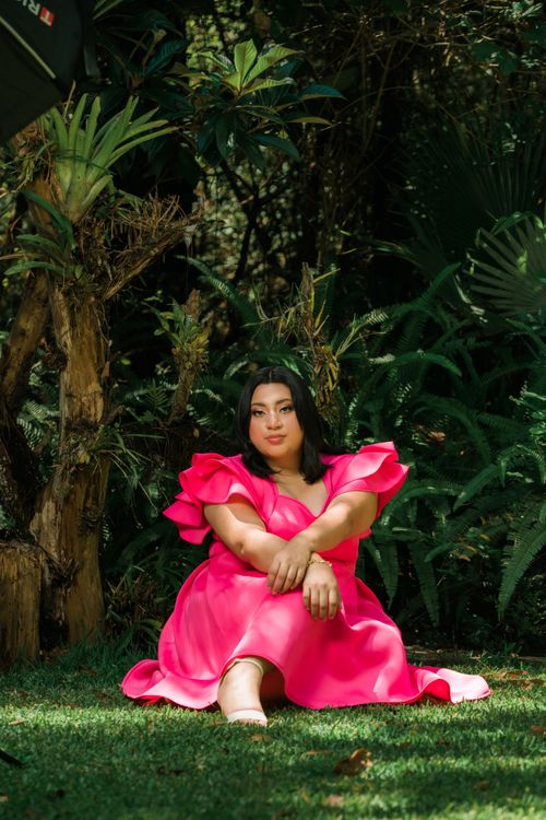 Woman Wearing a Pink Dress Sitting in a Garden · Free Stock Photo