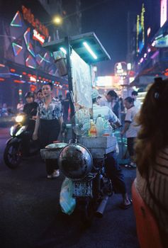 Bustling night street scene in Ho Chi Minh City, showcasing vibrant urban life and street vendors.