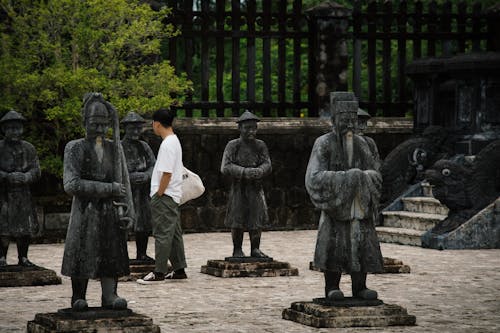 Tourist Walking Among Mandarin Soldiers Statues of Khai Dinh Tomb