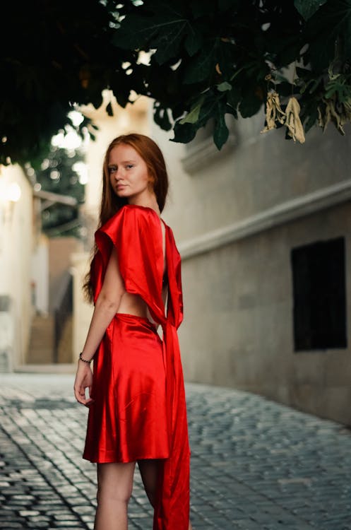 Young Redhead Model in Satin Red Dress