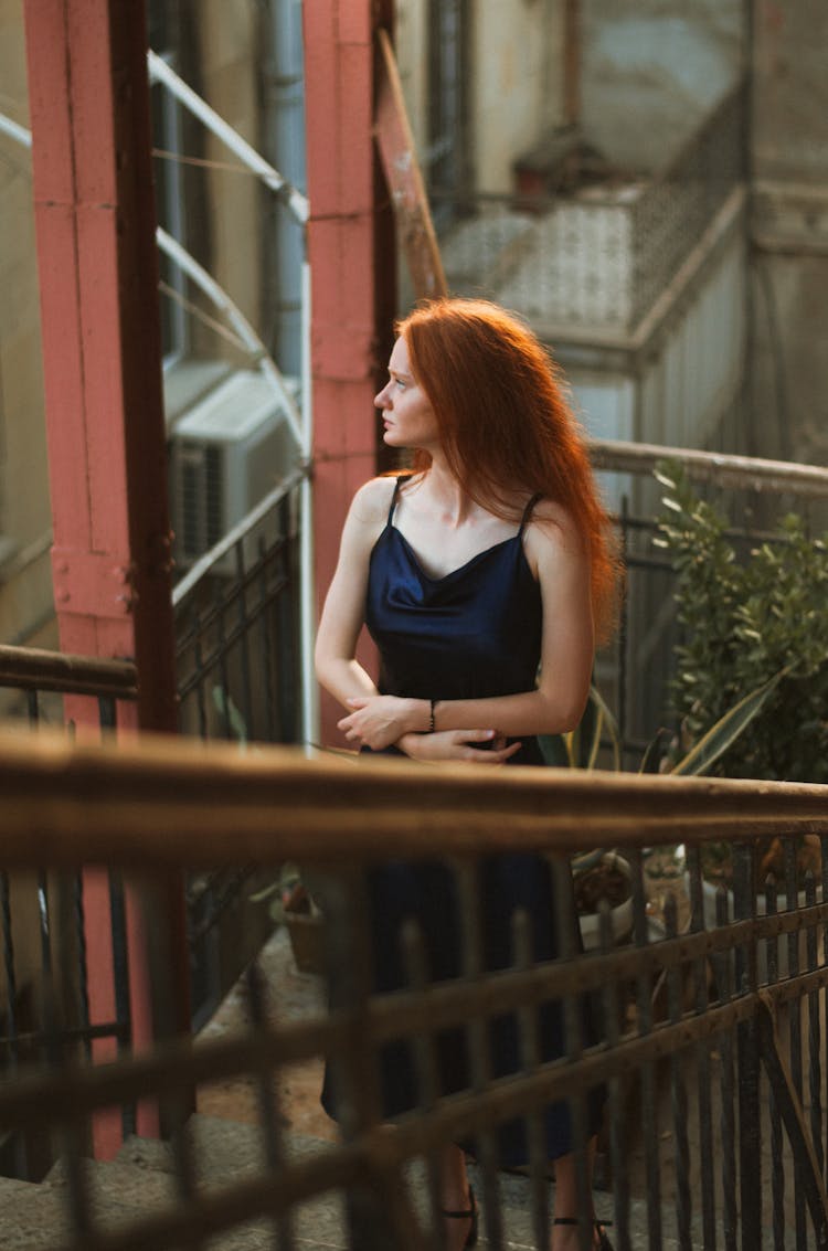 Redhead Model In Satin Dress On Staircase