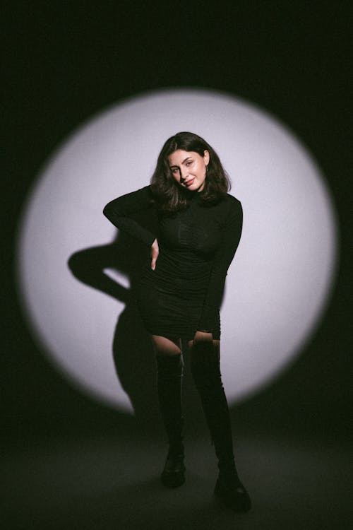 Young Model in a Black Mini Dress Posing in the Studio