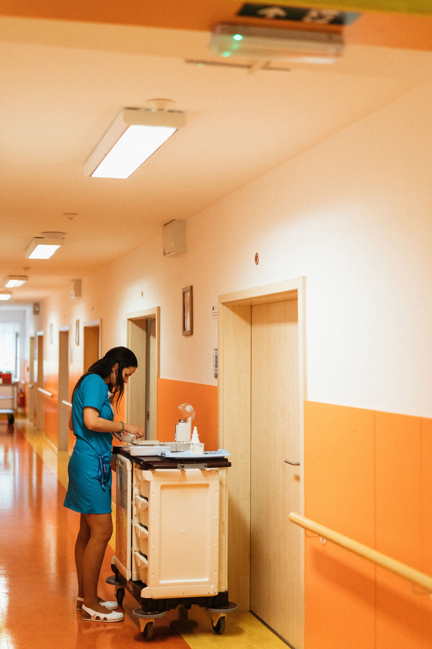 Nurse responding to patient-care needs in a hospital corridor