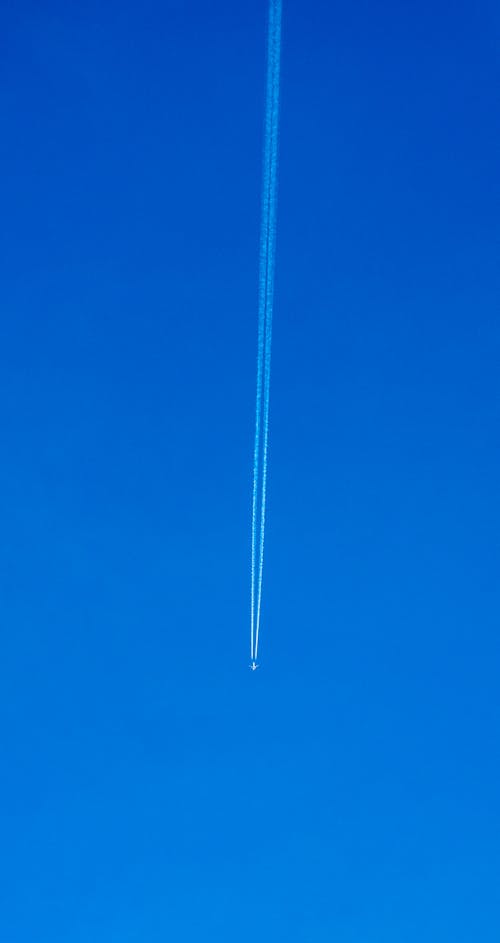 Airliner Leaving Trails of Smoke in the Blue Sky