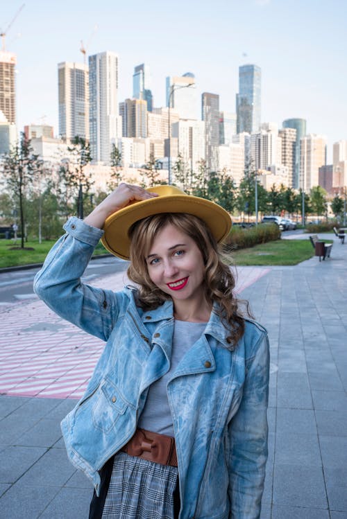 Smiling Woman in Jean Jacket and Hat