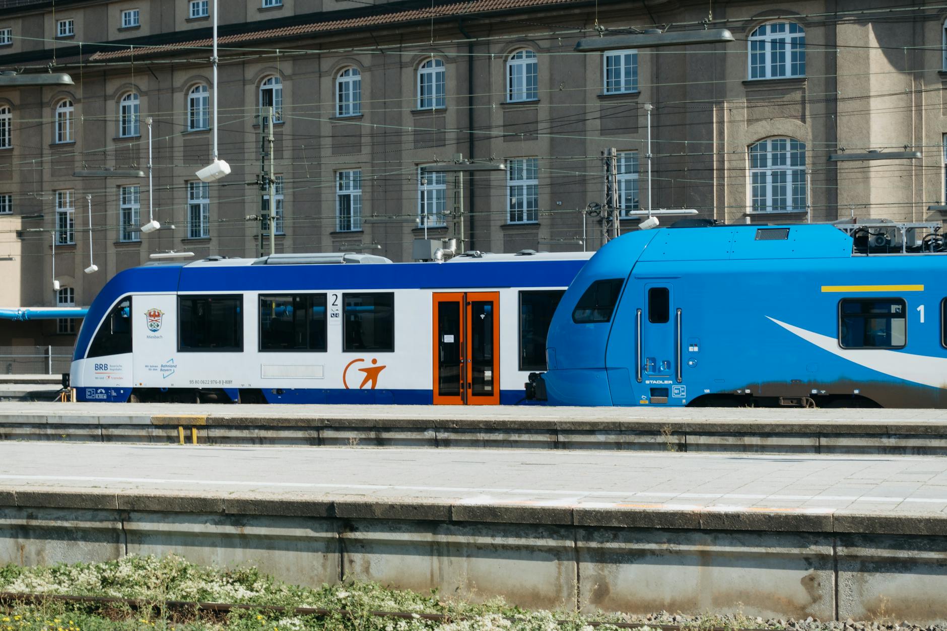 Bright blue train captured at a railway station in Munich, Germany.