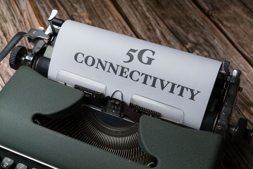 Free A juxtaposition of an old-fashioned typewriter and modern 5G connectivity text. Stock Photo
