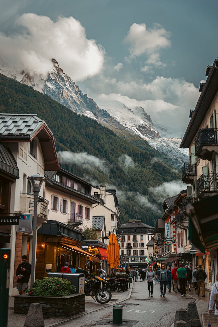 People On Narrow Street In A French Town Chamonix At The Foot Of The Mountains