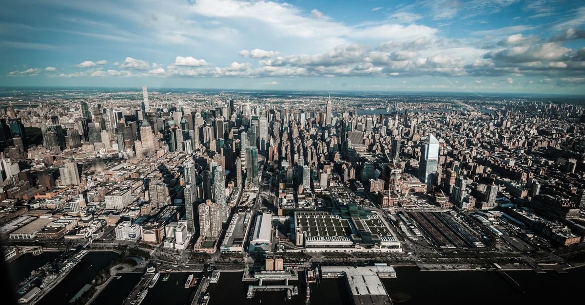 Stunning aerial view of Midtown Manhattan's skyline featuring iconic skyscrapers and the Hudson River.