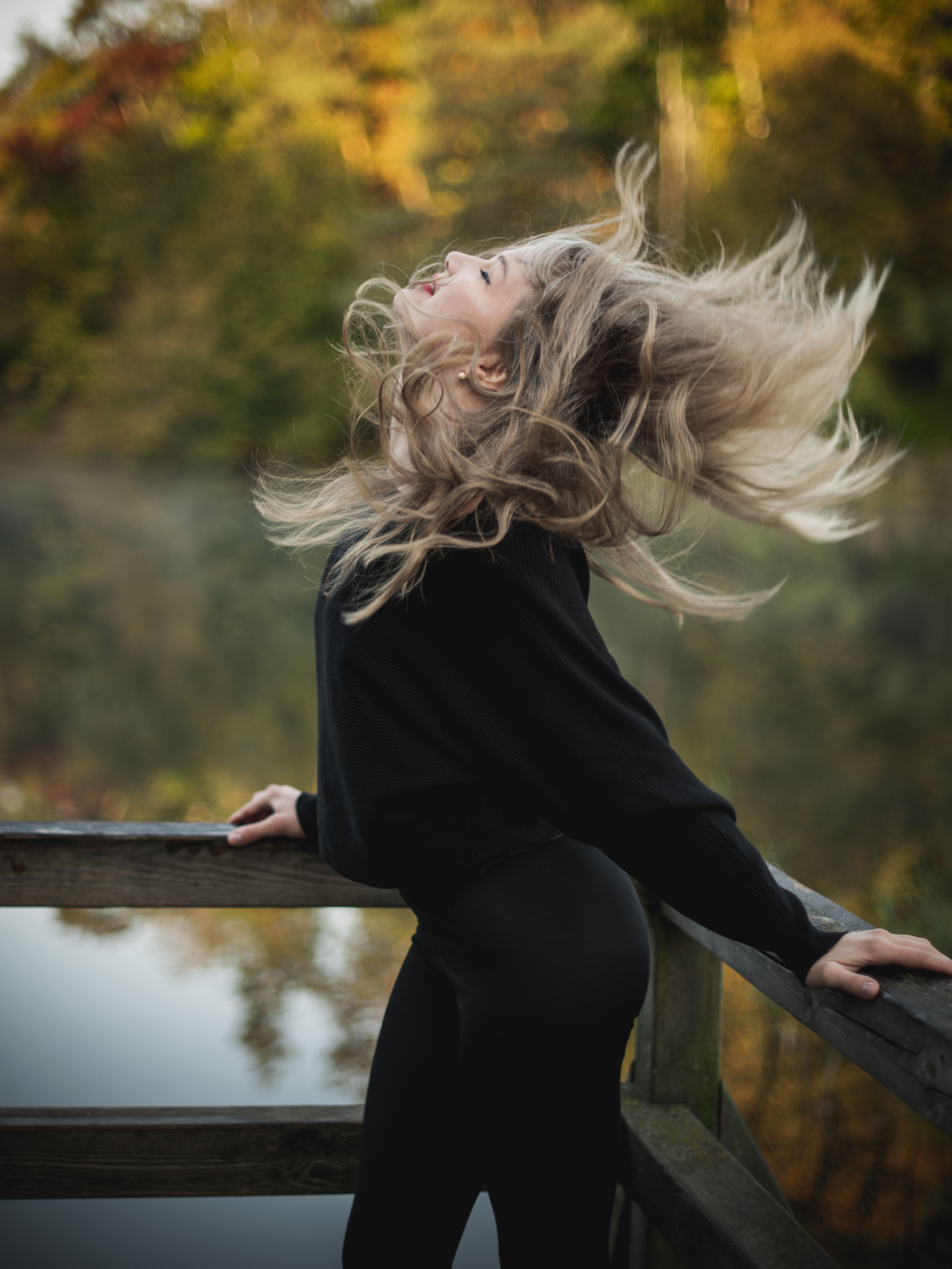 A woman with her hair blowing in the wind · Free Stock Photo