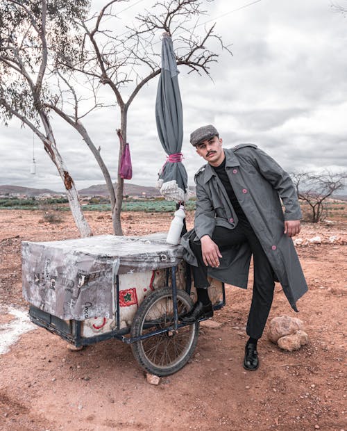 Man in Coat Standing with Trailer