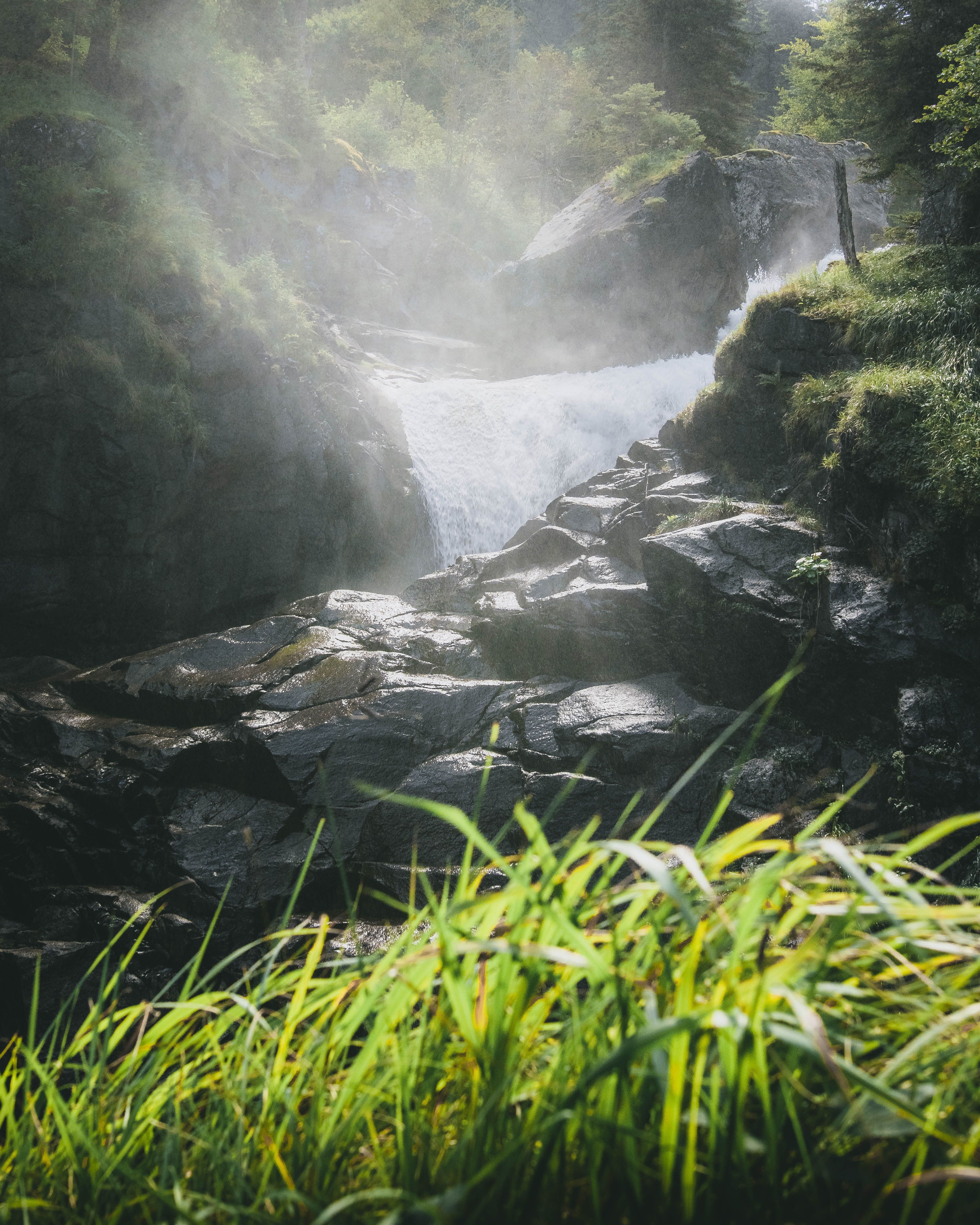 Rocks and Waterfall behind · Free Stock Photo