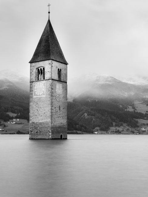 Historic bell tower emerging from the Reschensee lake in Trentino-South Tyrol, Italy.