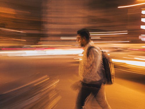 Lights around Walking Man at Night