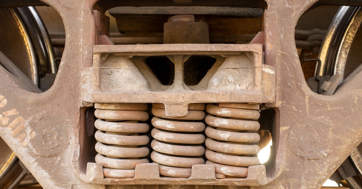 Detailed view of rusty train suspension system with springs in Reads Landing, MN.