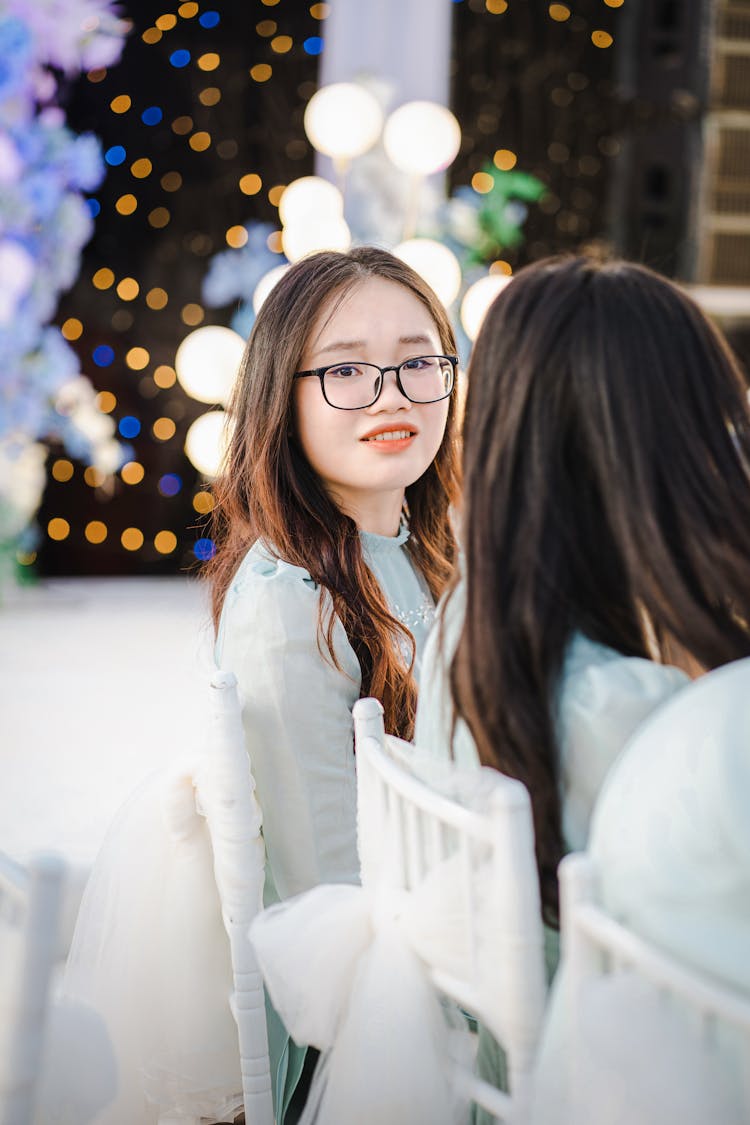 Smiling Young Woman Sitting At The Table At A Wedding