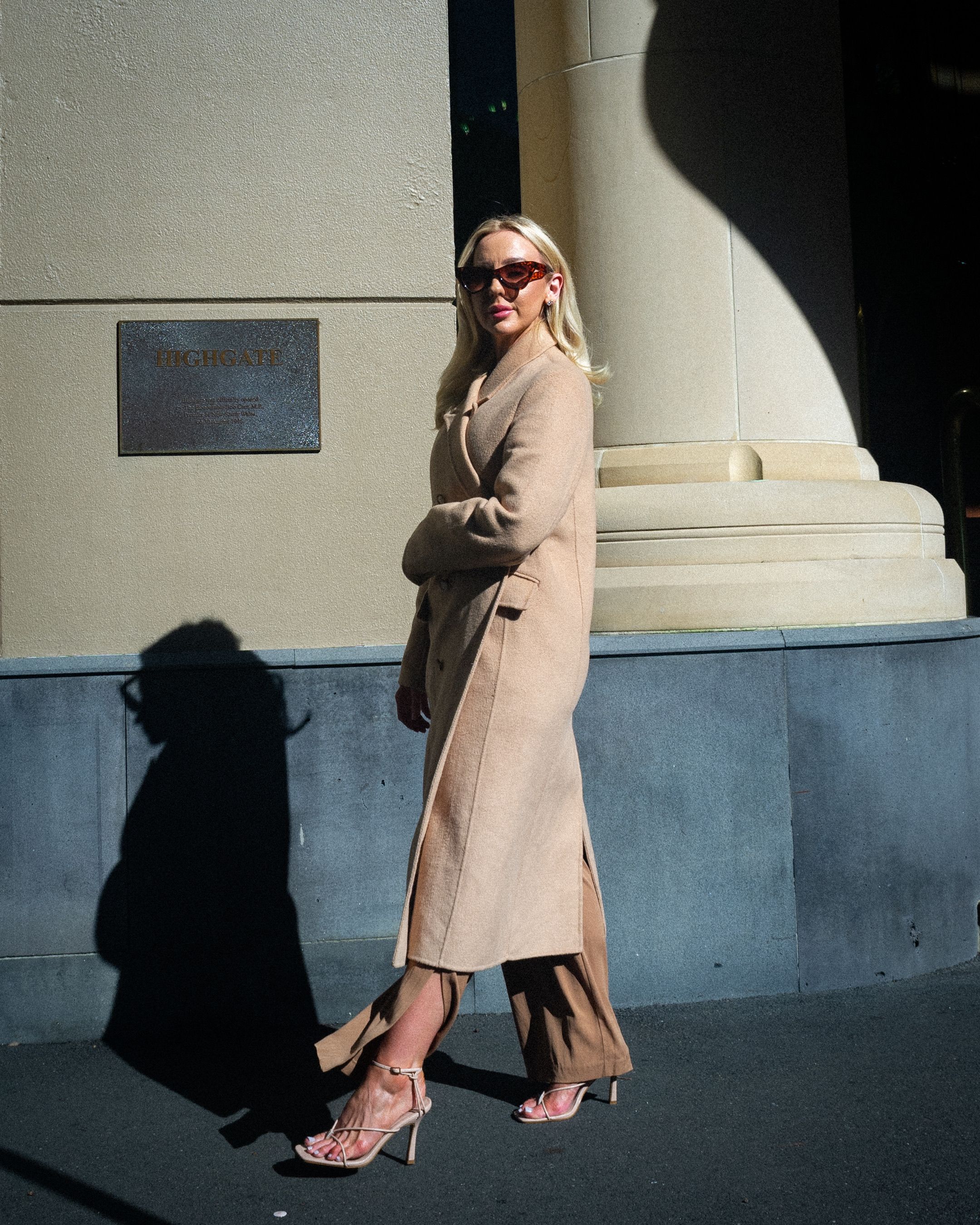 Woman Wearing a Beige Coat Walking on a Street · Free Stock Photo