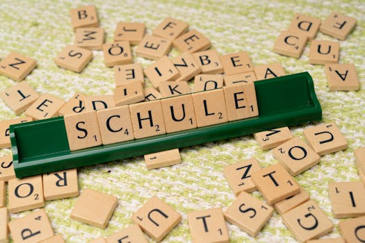 Word tiles spelling 'Schule' on table, ideal for language learning concepts.