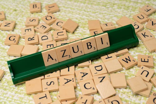A scrabble board with the word azubi written on it