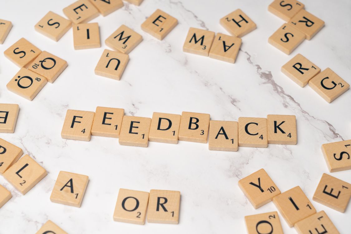 scrabble tiles spelling Feedback on marble background
