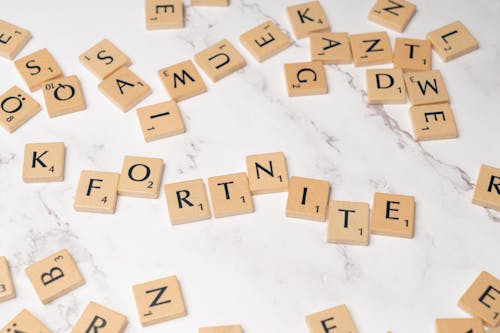 Scrabble letters spelling fortnite on a marble table
