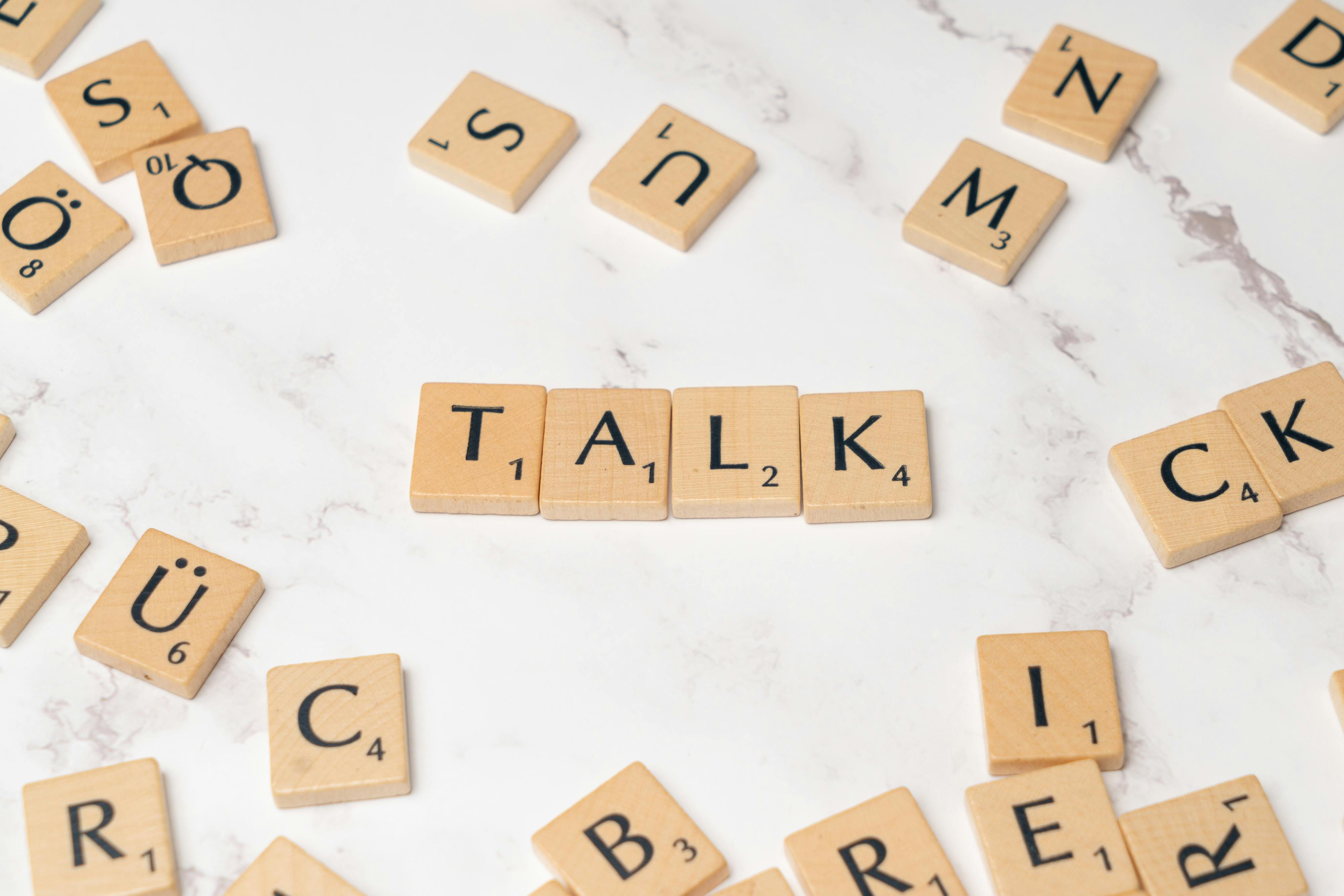 the word talk is spelled out in scrabble letters