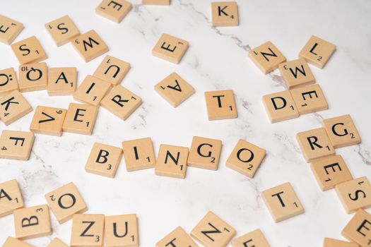 Scrabble letters arranged on a white marble surface