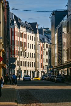 A vibrant street view in Riga's Old Town showcasing elegant architecture under a blue sky.