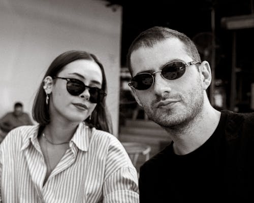 Black and White Photo of a Woman and a Man Wearing Sunglasses