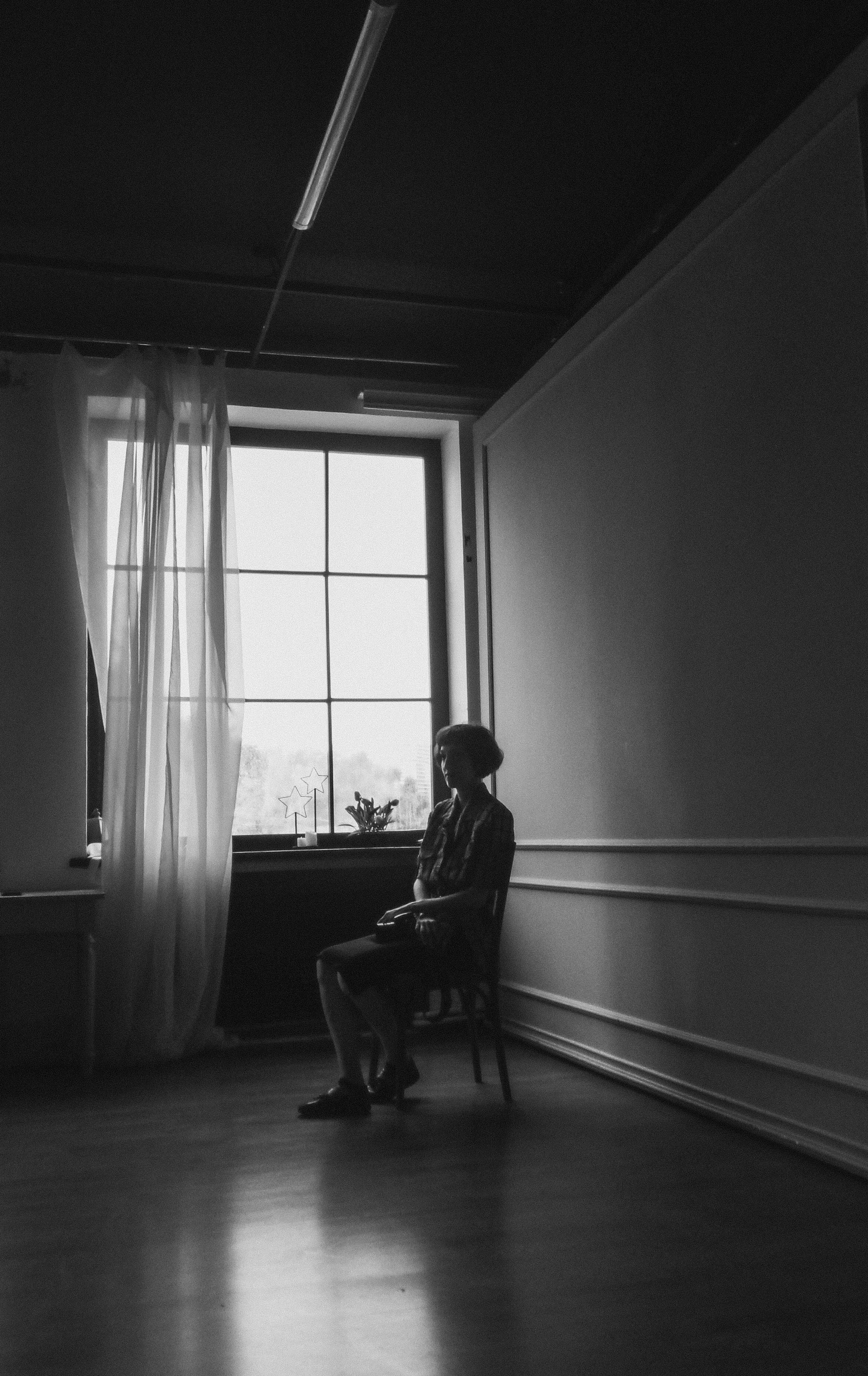 Black and White Shot of a Woman Sitting in a Chair · Free Stock Photo