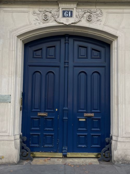 Free A striking pair of blue double doors with intricate carvings and trim, numbered 61. Stock Photo