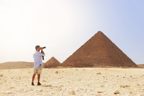 Free Man Taking Photo of the Great Pyramid Stock Photo