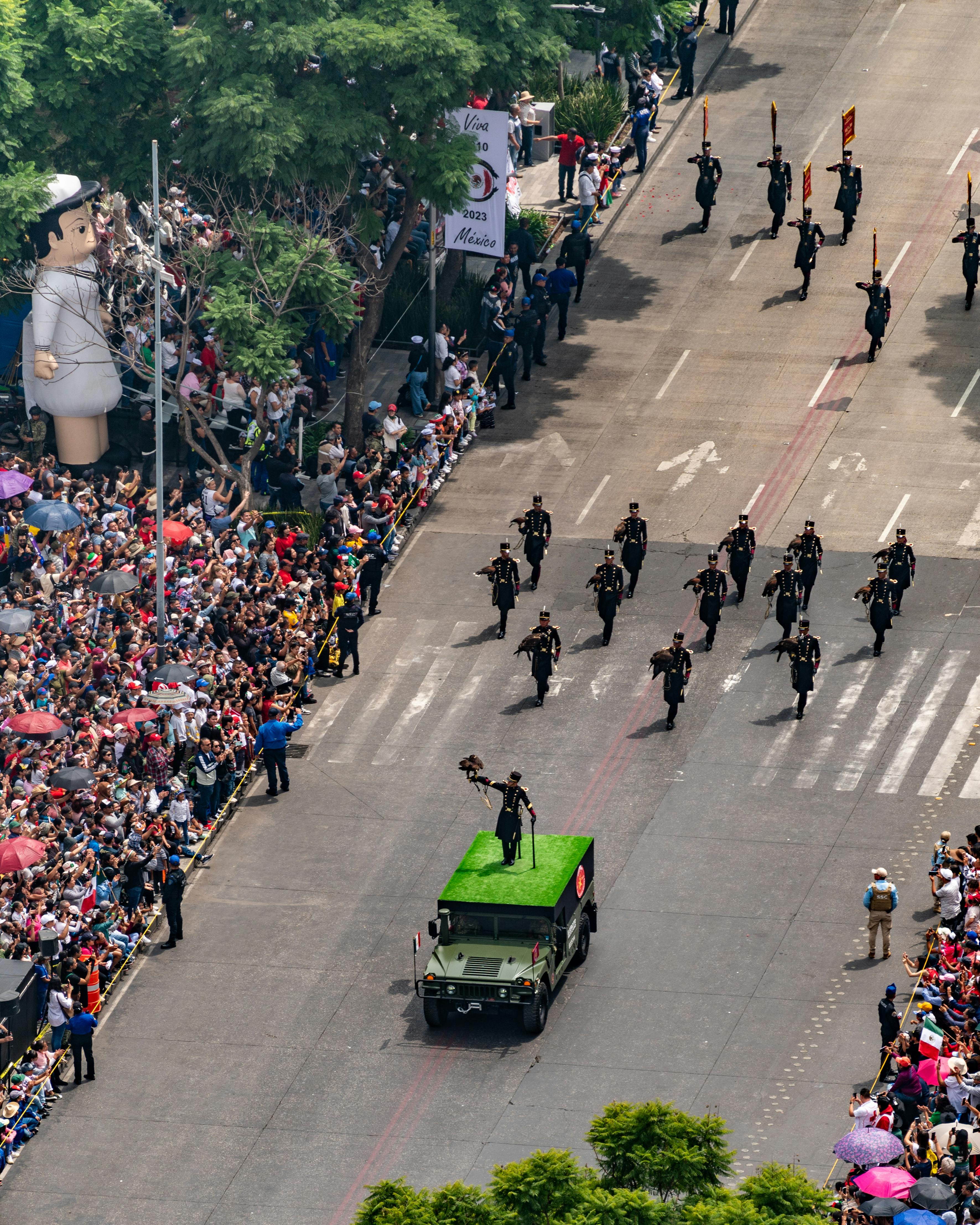 a parade of soldiers marching down a street