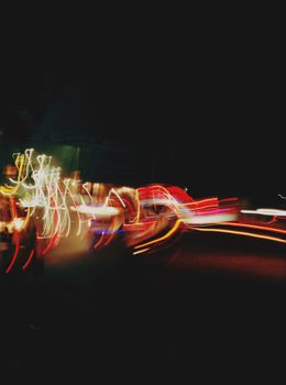 Blurred light trails creating dynamic patterns in a night urban scene.
