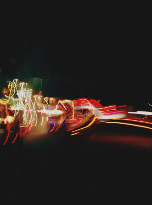 Free Blurred light trails creating dynamic patterns in a night urban scene. Stock Photo