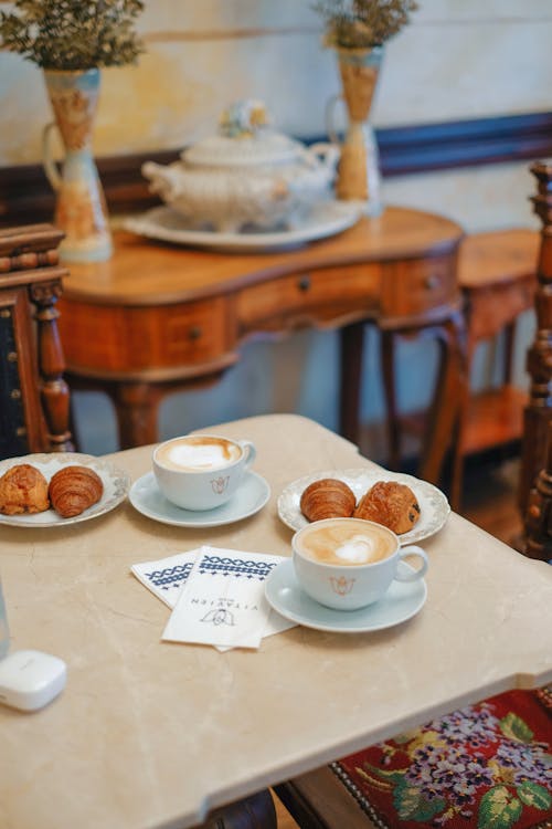 Croissants and Coffee Cups on Table