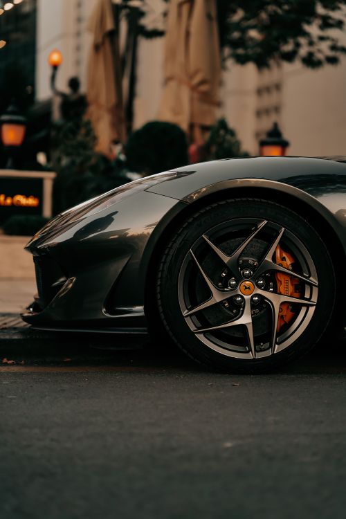 Free Close-up of a luxurious supercar wheel on a dark city street in Ankara, showcasing urban elegance. Stock Photo