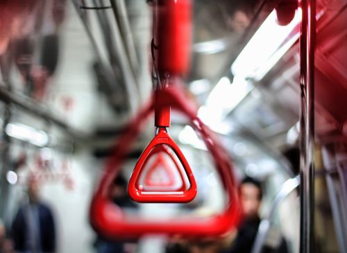 Free Close-up of red handles inside a moving Istanbul Metro, showcasing public transit vibe. Stock Photo