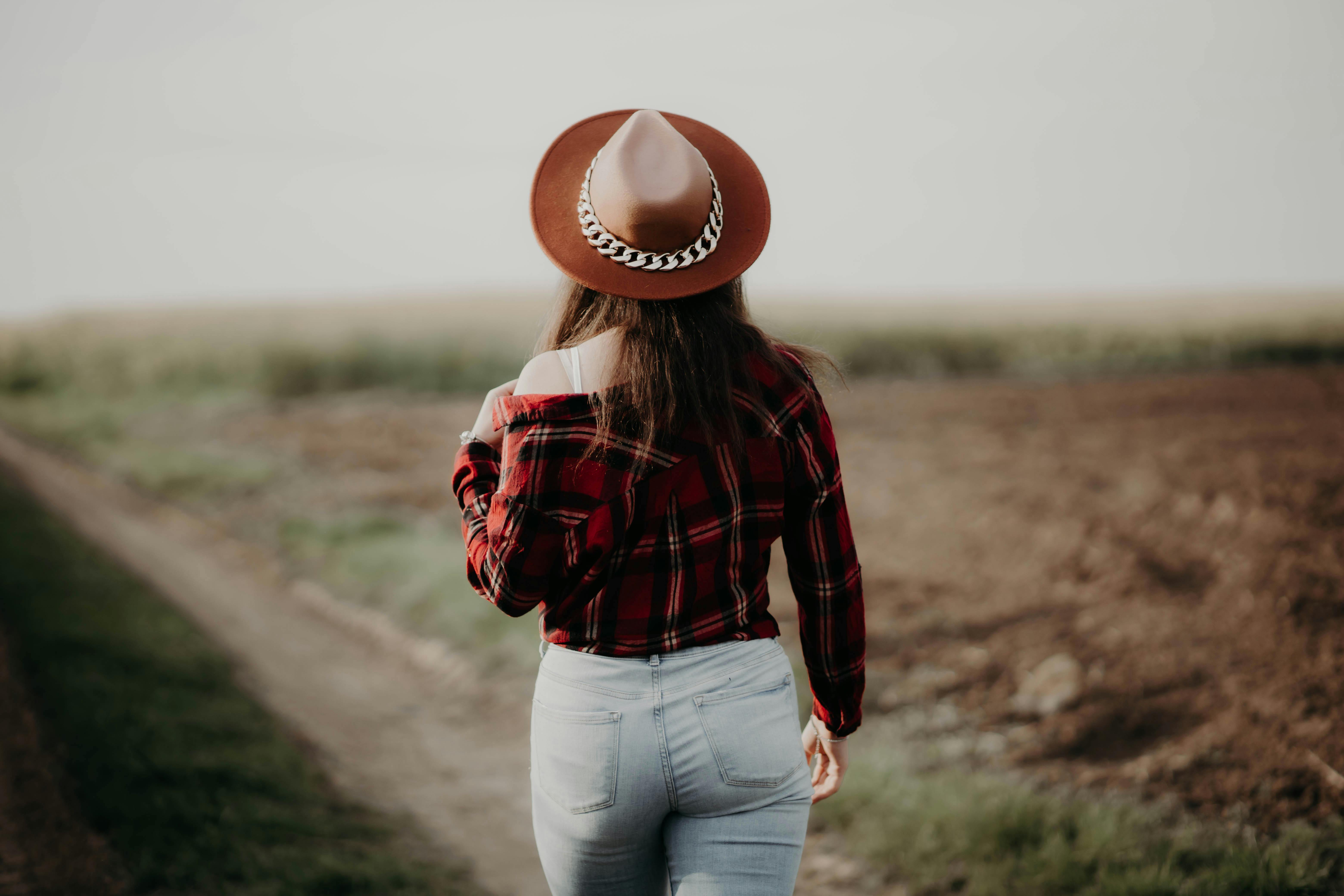 Back View of a Woman Putting Up a Wallpaper on the Wall · Free Stock Photo