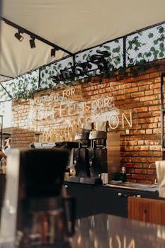 Stylish coffee shop interior featuring a brick wall and modern coffee machines.