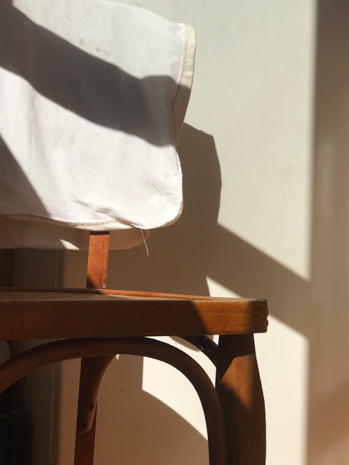 White Cloth Hanging on a Wooden Chair