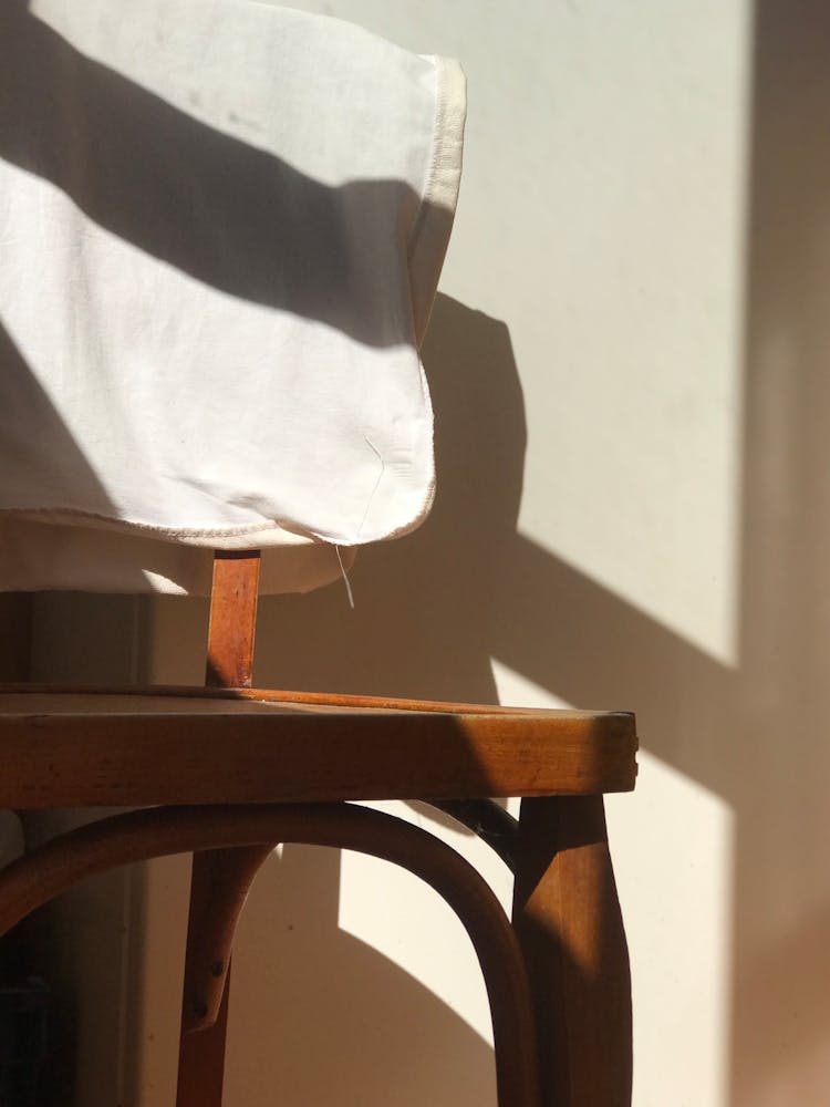 White Cloth Hanging On A Wooden Chair