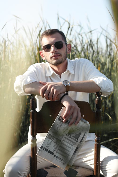 Elegant Man with Sunglasses Sitting on Chair