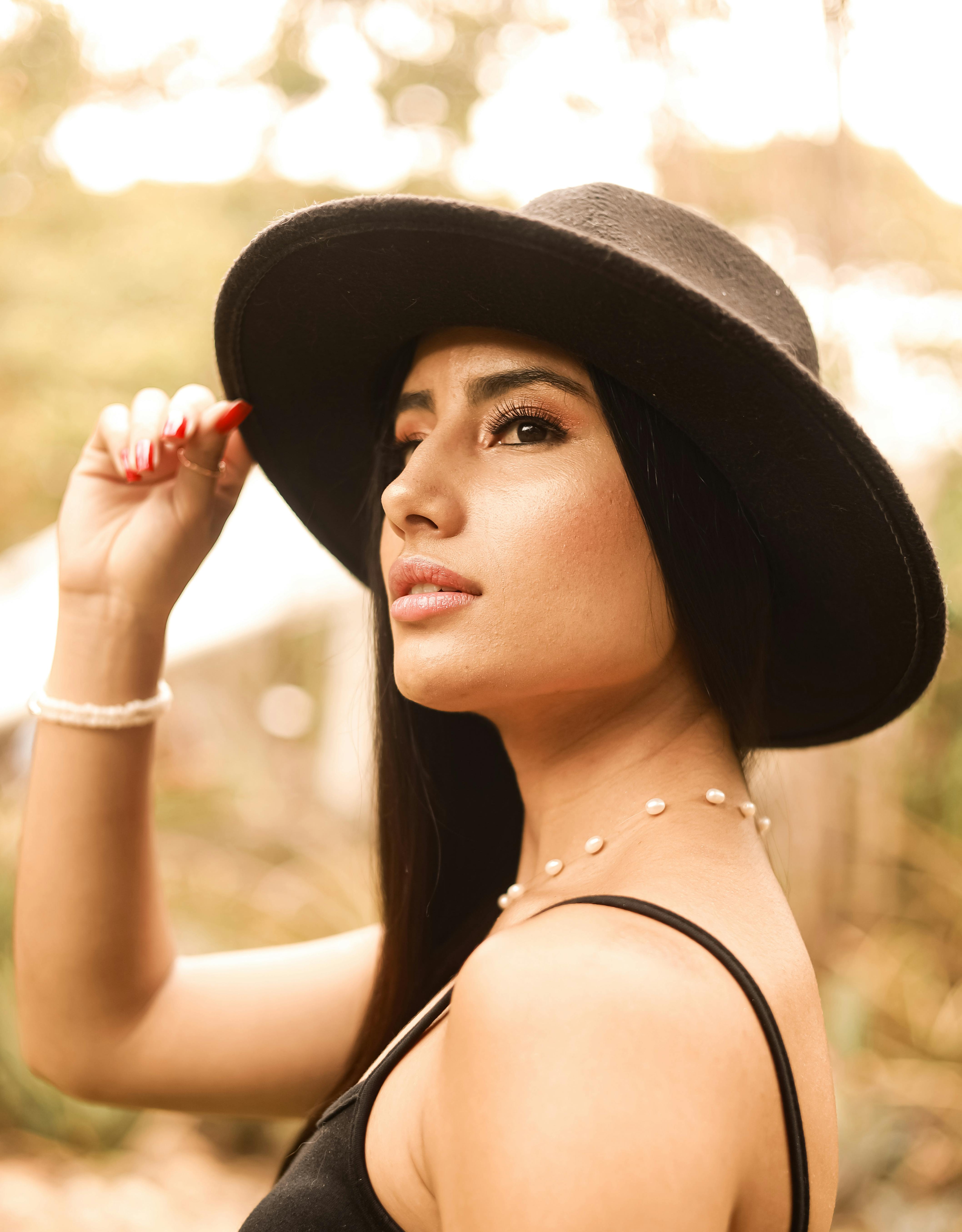 young girl, dark-skinned girl, smiling girl, brunette girl, hat with a wide  brim, black hat