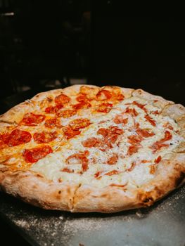Tasty close-up of mozzarella and pepperoni pizza with a classic crust, perfect for Italian cuisine lovers.