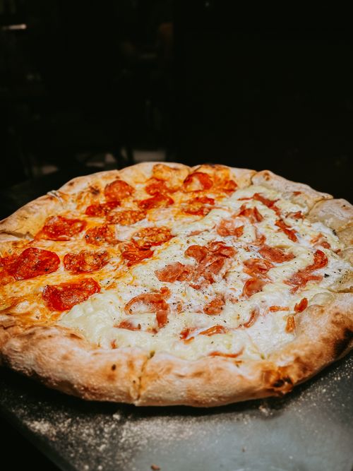 Free Tasty close-up of mozzarella and pepperoni pizza with a classic crust, perfect for Italian cuisine lovers. Stock Photo