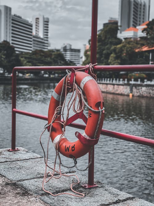Lifebuoy Hanging on a Railing Over the Canal