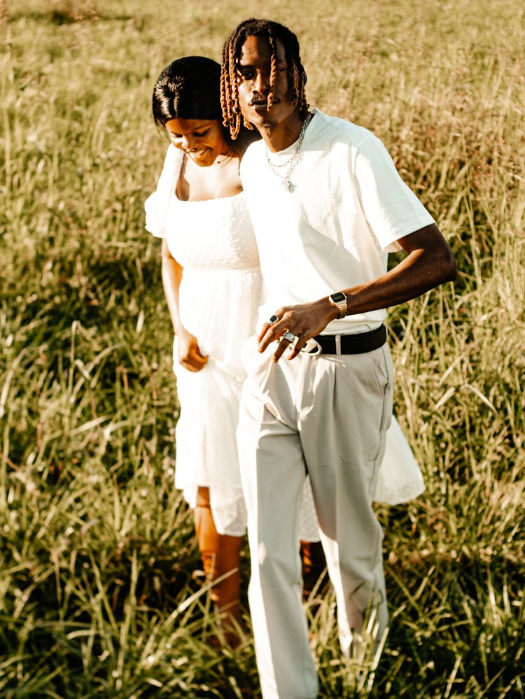 Couple Walking In The Pasture